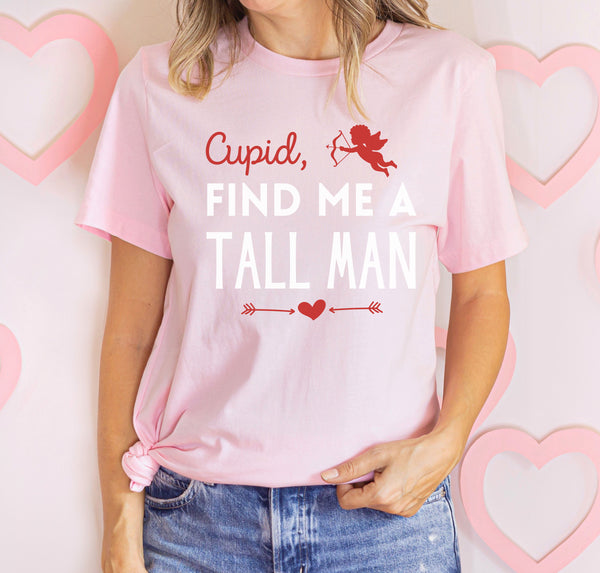 Tall woman wearing a Cupid, Find Me A Tall Man T-Shirt for Valentine's Day.