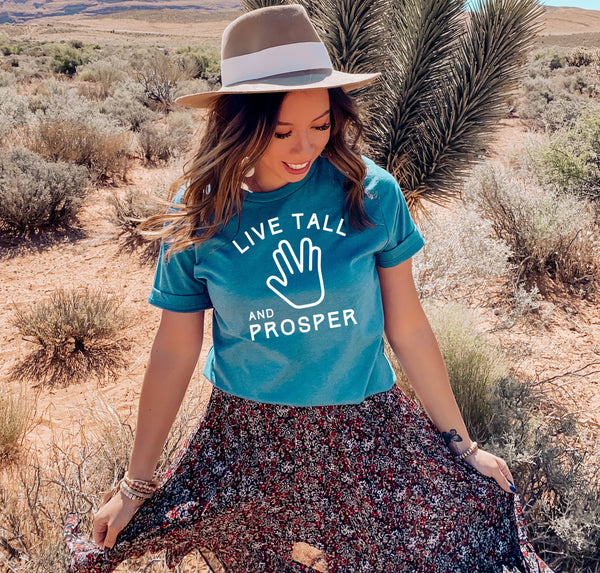 Woman model wearing a Star Trek graphic tee that says "Live Tall and Prosper".