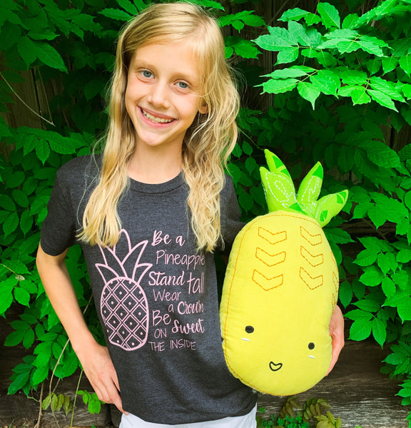 Graphic kids t-shirt with the quote, "Be a pineapple, stand tall, wear a crown, and be sweet on the inside."