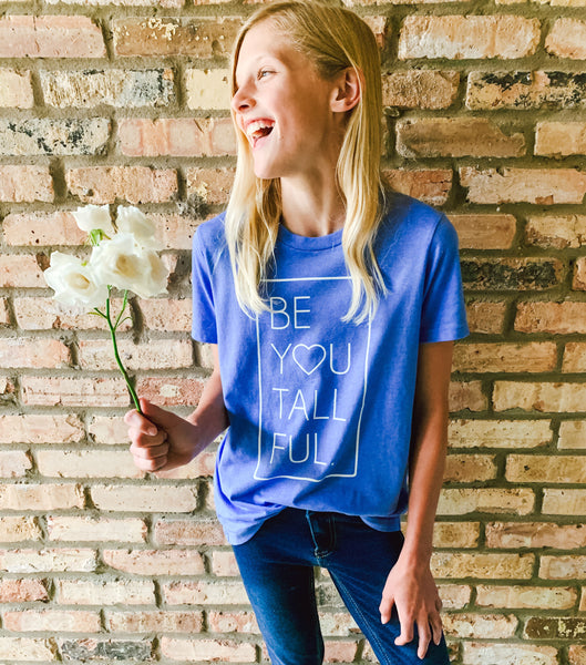 Young girl wearing a "Be You Tall Ful." tee in Columbia Blue Heather.