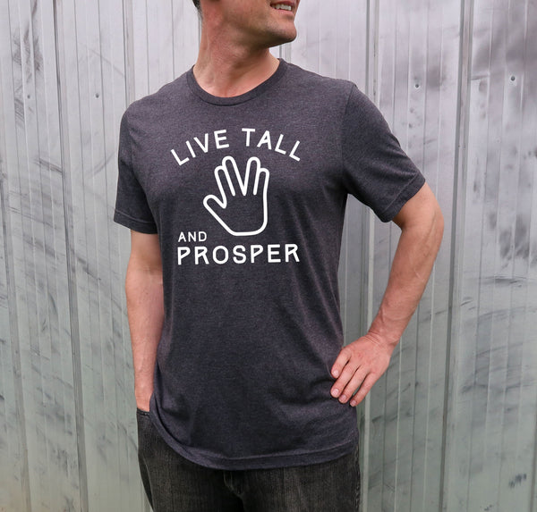 Male model wearing a Star Trek tee with the phrase "Live Tall and Prosper" and a trekkie hand design.