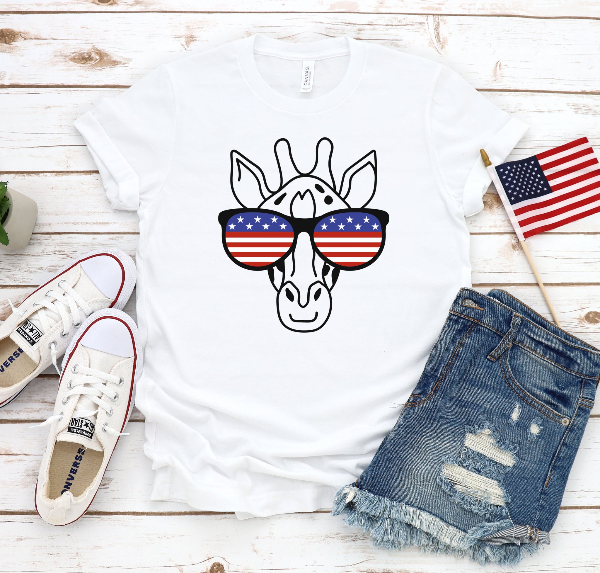 Funny, patriotic t-shirt for tall people with a giraffe's face wearing red, white, and blue glasses.