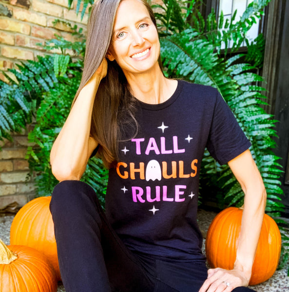 Tall woman wearing a funny Halloween graphic tee shirt with a "Tall Ghouls Rule" design.