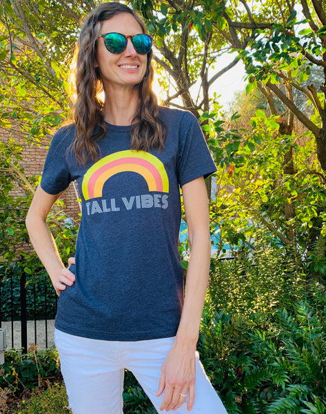 Model wearing a Bella + Canvas 3001 graphic vintage tee with the phrase "Tall Vibes"