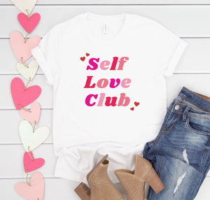 Valentine's Day women's graphic tee shirt that says "Self Love Club".'